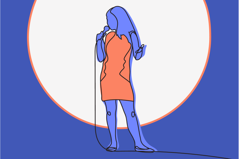 A woman in a sleeveless dress holds a microphone and sings on stage, standing in front of a large circular light, raising awareness about Pathological Demand Avoidance (PDA).